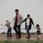 family-of-four-walking-at-the-street-2253879